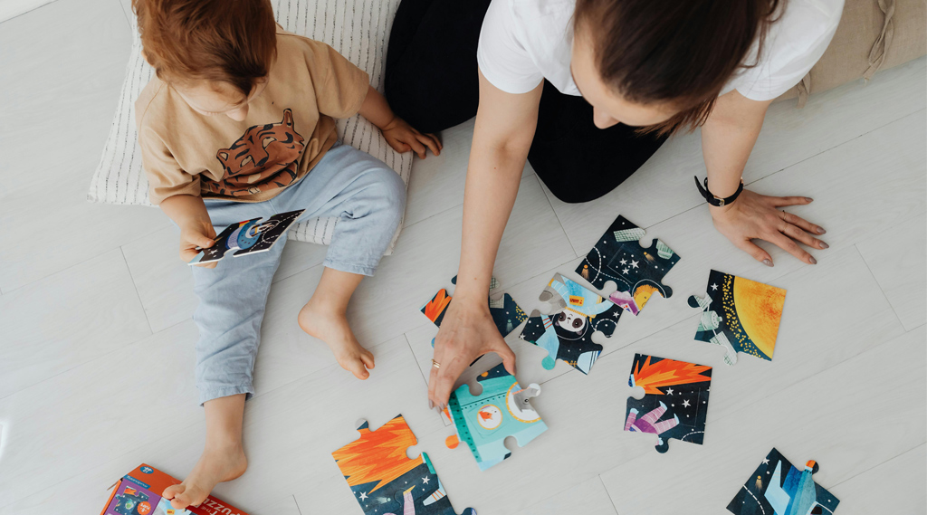 Una madre y un niño jugando con un puzzle